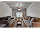 Comfortable living room with coffered ceiling, hardwood floors, and natural light from the window at 2020 Walking Horse Trl, Cumming, GA 30041