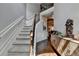 Elegant staircase with carpeted steps and decorative railing in a well-lit home at 2020 Walking Horse Trl, Cumming, GA 30041