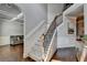 Elegant staircase with carpeted steps and decorative railing with a view of the Gathering room at 2020 Walking Horse Trl, Cumming, GA 30041