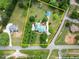 Aerial view showcasing the property's layout, including buildings, landscaping, and approximate boundary lines at 2620 Dr Bramblett Rd, Cumming, GA 30028