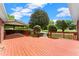 Spacious back deck overlooking a lush backyard and a covered outdoor seating area at 2620 Dr Bramblett Rd, Cumming, GA 30028