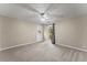 Bright bedroom featuring a ceiling fan, carpeted floors, and a door to the backyard at 2620 Dr Bramblett Rd, Cumming, GA 30028