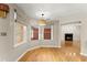 Dining area featuring hardwood floors, a modern light fixture and large windows with natural light at 2620 Dr Bramblett Rd, Cumming, GA 30028