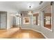 Dining area featuring hardwood floors, a modern light fixture and large windows overlooking the deck at 2620 Dr Bramblett Rd, Cumming, GA 30028