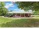 Inviting brick home with a covered front porch and manicured landscaping enhancing its curb appeal at 2620 Dr Bramblett Rd, Cumming, GA 30028