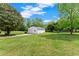 Large garage with well-maintained green lawn and sunny skies at 2620 Dr Bramblett Rd, Cumming, GA 30028