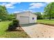 A detached one-car garage with white siding, a gable roof, and a traditional overhead door at 2620 Dr Bramblett Rd, Cumming, GA 30028