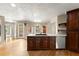Open kitchen featuring stainless steel appliances, hardwood floors, granite counters, and a kitchen island at 2620 Dr Bramblett Rd, Cumming, GA 30028