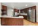 Updated kitchen featuring stainless steel appliances, hardwood floors, granite counters, and a kitchen island at 2620 Dr Bramblett Rd, Cumming, GA 30028