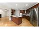 Updated kitchen featuring stainless steel appliances, hardwood floors, granite counters, and a kitchen island at 2620 Dr Bramblett Rd, Cumming, GA 30028