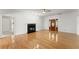 Open-concept living room with hardwood floors and cozy fireplace at 2620 Dr Bramblett Rd, Cumming, GA 30028