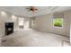 Spacious main bedroom featuring trey ceiling, neutral walls, a ceiling fan and cozy fireplace at 2620 Dr Bramblett Rd, Cumming, GA 30028