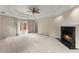 Relaxing main bedroom with backyard access, a cozy fireplace, and neutral color palette at 2620 Dr Bramblett Rd, Cumming, GA 30028