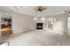Inviting main bedroom featuring a cozy fireplace, neutral color palette, and access to the kitchen at 2620 Dr Bramblett Rd, Cumming, GA 30028