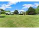 A large property with a well-maintained lawn, mature trees, and outbuildings, creating a park-like setting at 2620 Dr Bramblett Rd, Cumming, GA 30028
