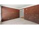 Finished room with neutral carpet and brick accent wall at 2620 Dr Bramblett Rd, Cumming, GA 30028