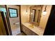 Classic bathroom with a marble counter vanity, decorative mirror and fixtures, and vintage wallpaper at 1110 Blackwell Rd, Marietta, GA 30066