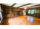 Spacious living room featuring wood paneling, a brick fireplace, and hardwood floors at 1110 Blackwell Rd, Marietta, GA 30066