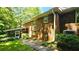Exterior shot showcasing the brick facade, screened-in porch, and lush greenery around the home at 1110 Blackwell Rd, Marietta, GA 30066
