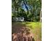 View of home's exterior in yard surrounded by trees at 2700 Snapfinger Rd, Decatur, GA 30034