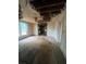 Living room with exposed ceiling, dated carpet, and an opening leading into the kitchen at 2700 Snapfinger Rd, Decatur, GA 30034