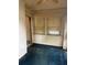 Enclosed sun room featuring windows with blinds, white brick detail, and blue carpet at 2700 Snapfinger Rd, Decatur, GA 30034