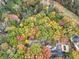 Scenic aerial shot of the property featuring mature trees with autumn colors and a pool at 2775 Hogan Rd, Atlanta, GA 30344