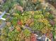 Overhead shot with vibrant trees showing a home nestled in a serene, wooded landscape at 2775 Hogan Rd, Atlanta, GA 30344