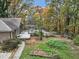 View of a deck off the rear of the home, and a partially fenced yard with trees at 2775 Hogan Rd, Atlanta, GA 30344