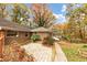 Brick home featuring patio and wood deck, with autumn foliage at 2775 Hogan Rd, Atlanta, GA 30344