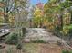 Backyard featuring a sports court, deck, and a surrounding of lush trees at 2775 Hogan Rd, Atlanta, GA 30344