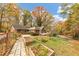 Brick home with mature trees, back patio, wood deck, and garden boxes in the backyard at 2775 Hogan Rd, Atlanta, GA 30344