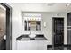 Bathroom featuring black tile, white vessel sink, and modern fixtures at 2775 Hogan Rd, Atlanta, GA 30344