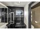 Modern bathroom featuring dark tile, a window, and a bathtub-shower combination at 2775 Hogan Rd, Atlanta, GA 30344