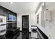 Sleek bathroom featuring black tile, vessel sink, and modern fixtures at 2775 Hogan Rd, Atlanta, GA 30344