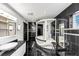 Modern bathroom featuring a glass enclosed shower, black tile, and vessel sink at 2775 Hogan Rd, Atlanta, GA 30344