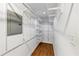 Walk-in closet featuring white wire shelving, wood floor and access to electrical panel at 2775 Hogan Rd, Atlanta, GA 30344