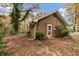 Brick home exterior featuring a rear entrance, surrounded by trees and autumn foliage at 2775 Hogan Rd, Atlanta, GA 30344