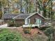 Exterior view of the back of the home with a deck and luscious landscaping at 2775 Hogan Rd, Atlanta, GA 30344