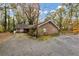 Brick home with mature trees, driveway, and landscaping at 2775 Hogan Rd, Atlanta, GA 30344