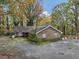 Charming single-story brick home with mature trees and a mossy driveway at 2775 Hogan Rd, Atlanta, GA 30344