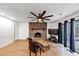 Bright living room featuring a brick fireplace, wood floors, and sliding glass doors to the outside at 2775 Hogan Rd, Atlanta, GA 30344