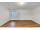 Bright living room features wood flooring, fresh white paint, and a door with glass inset at 2775 Hogan Rd, Atlanta, GA 30344