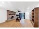 Bright living room featuring a brick fireplace, wood floors, and sliding glass doors to the outside at 2775 Hogan Rd, Atlanta, GA 30344