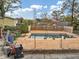 Backyard pool features a chain-link fence and wooden privacy fence, offering a relaxing retreat at 2775 Hogan Rd, Atlanta, GA 30344