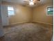 Spacious bedroom with neutral walls, carpet flooring, and natural light from two windows at 3026 Hidden Forest Dr, Snellville, GA 30078