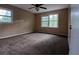 Bright bedroom with carpet, two windows, and a ceiling fan at 3026 Hidden Forest Dr, Snellville, GA 30078