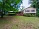 Traditional home with a manicured front yard and a mix of brick and siding exterior at 3026 Hidden Forest Dr, Snellville, GA 30078