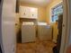 Laundry room with washer, dryer, and overhead cabinets at 3026 Hidden Forest Dr, Snellville, GA 30078