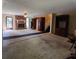 Spacious living room with brick fireplace, ceiling fan, and access to staircase at 3026 Hidden Forest Dr, Snellville, GA 30078